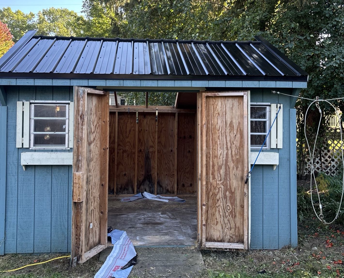New black metal roof on a backyard shed