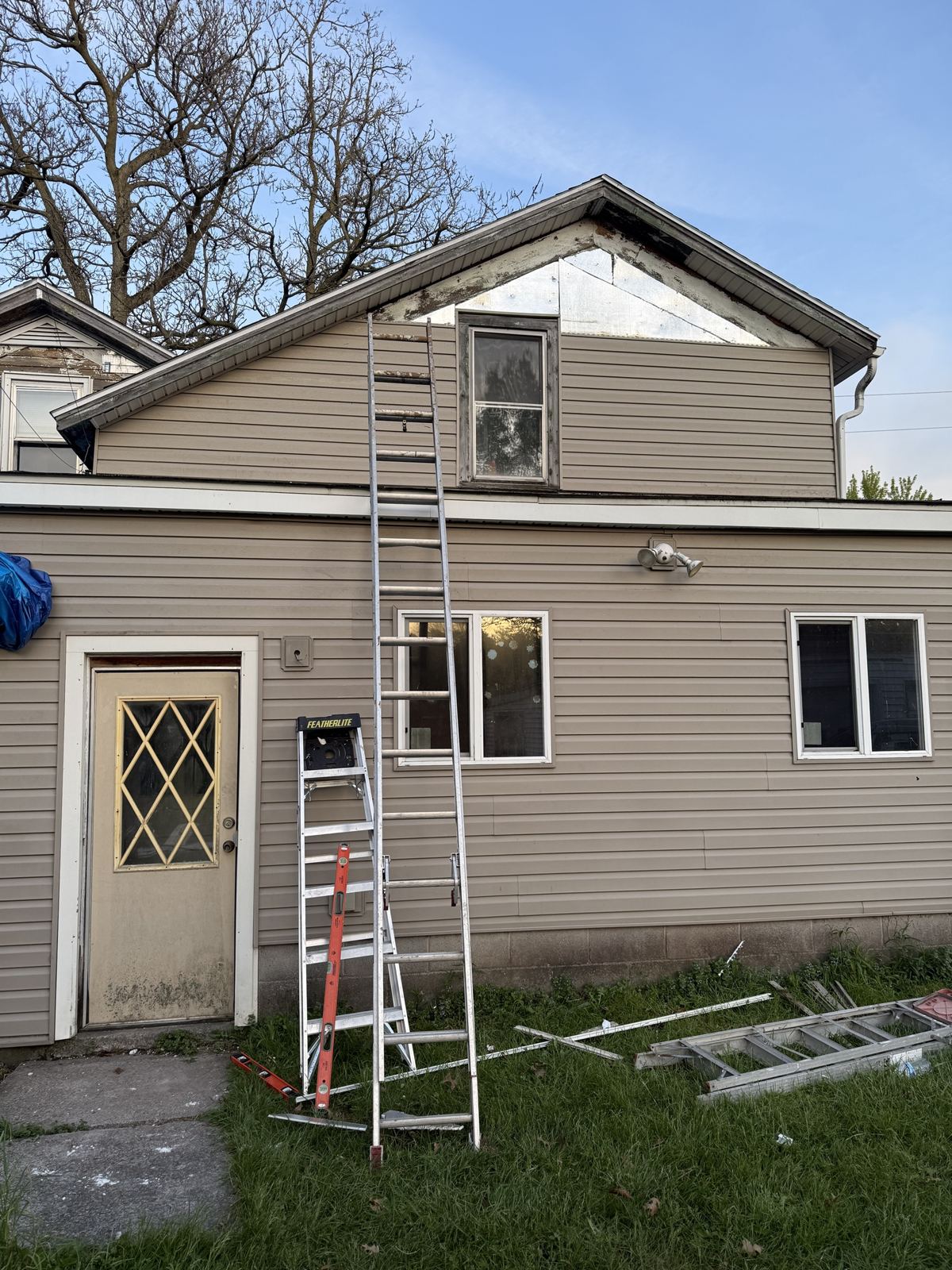 Siding job in progress on a two-story house
